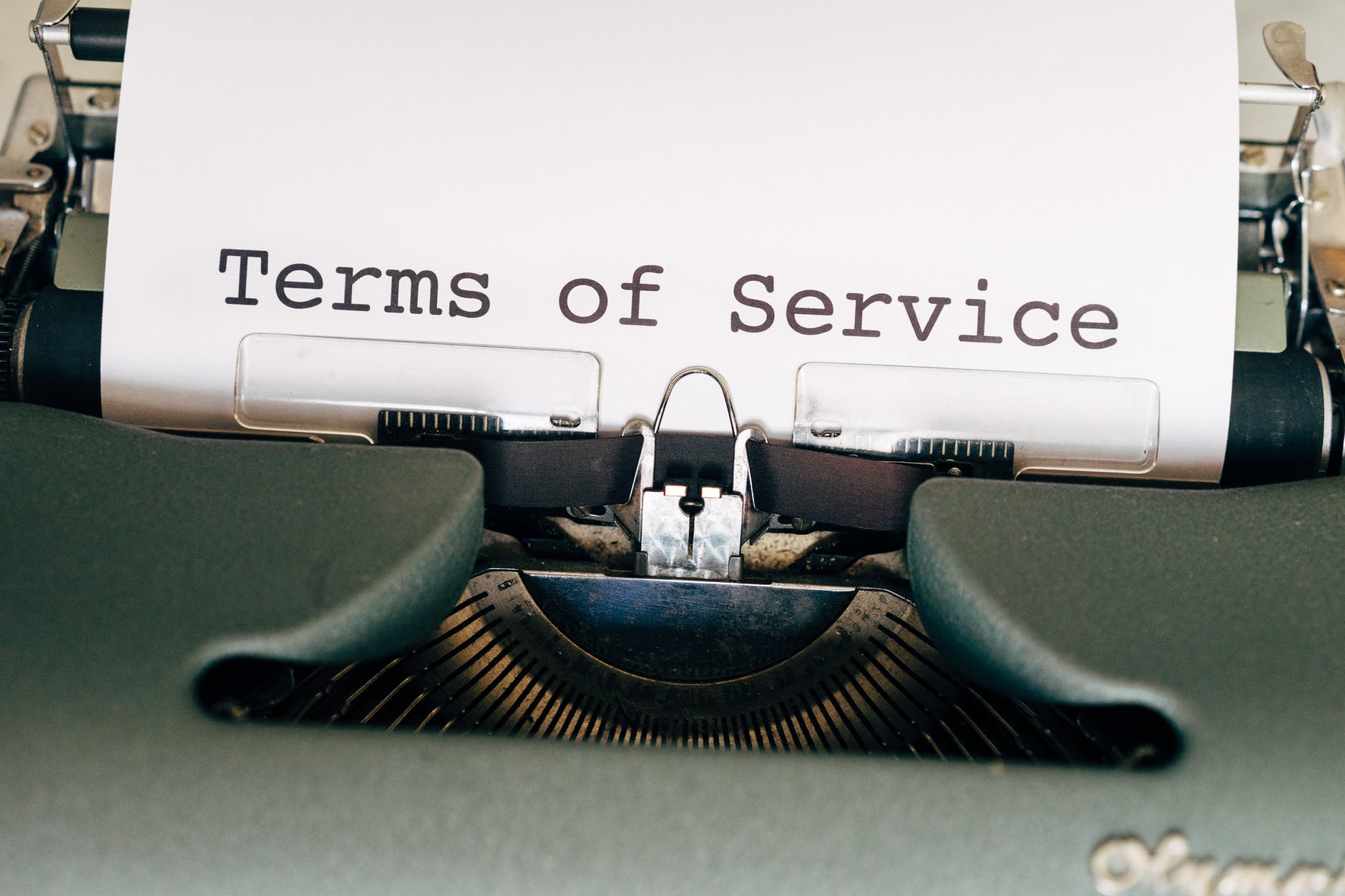 black and green typewriter with white paper